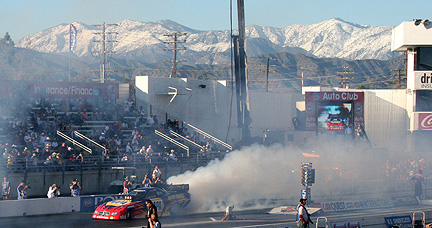 Capps' Funny Car burnout against snow capped mountains.