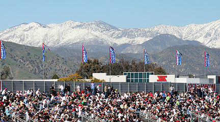 Grandstands against snow capped mountains.
